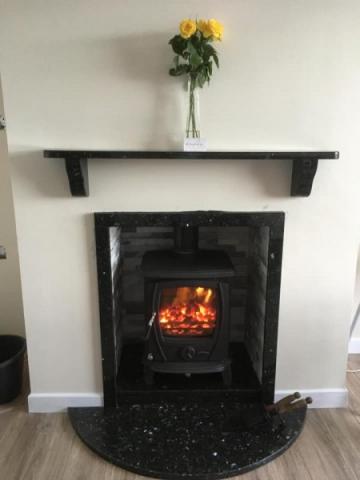 Small half moon hearth with granite shelf. All in blue pearl granite.